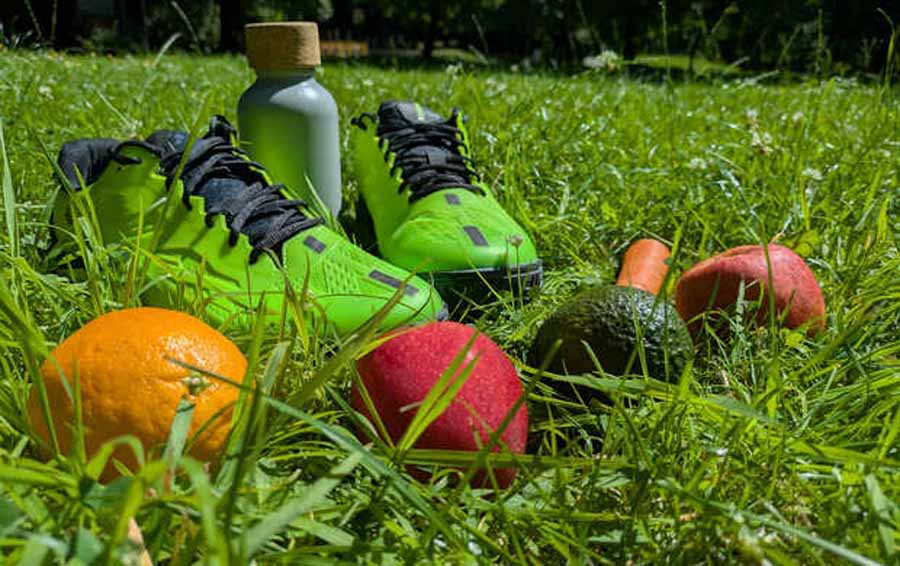 Symbolbild Obst und Sportschuhe auf Wiese