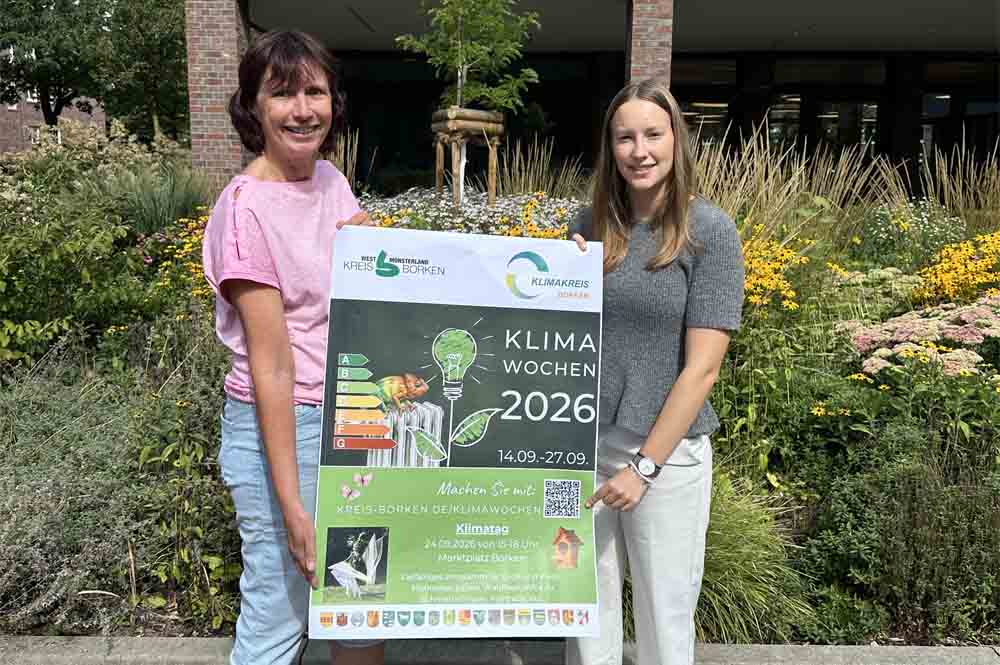 Zwei Frauen stellen das Plakat zu den Klimawochen vor